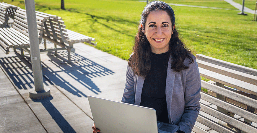 Computational biology Professor Bercem Dutagaci sitting in the quad.