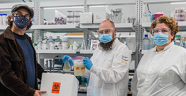 Professor Beutel (left) delivers samples to Professor Sistrom (center) and his doctoral student Shari Larsen (right).